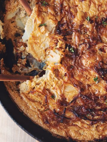 vegan caramelized onion scalloped potatoes in a skillet